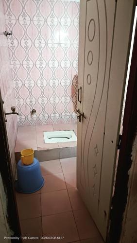 a small bathroom with a toilet in a room at Durga Nivas in Kurnool