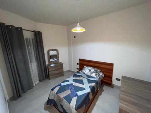 a bedroom with a bed and a mirror in it at Sky Garden Appartement in Quatre Bornes