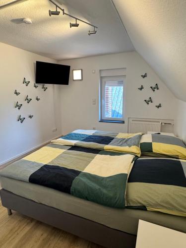 a bedroom with a bed with birds on the wall at Seequartier Borken in Borken