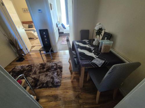 a dining room with a long table and chairs at Cosy and Bright 3-bedroom flat in Glasgow