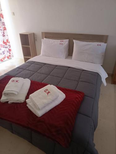 a large bed with two towels on top of it at Sroom Karditsa in Karditsa