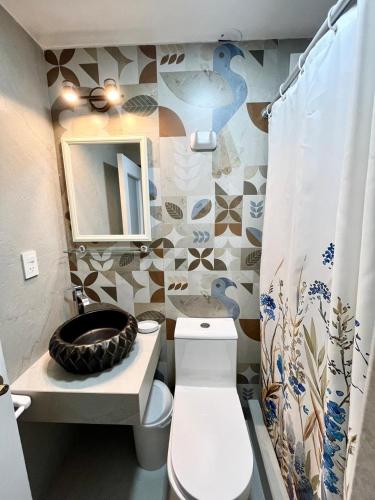 a bathroom with a toilet and a sink and a mirror at Casa Cerezos in Ica