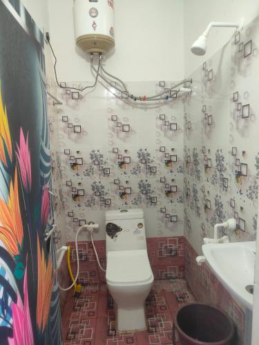 a bathroom with a toilet and a sink at SRI PADMAVATHI NiVAS in Pithāpuram