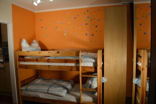 a bunk bed room with two bunk beds and a wall with balloons at Hei un Urlaub in Neu Damerow