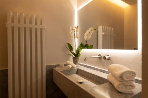a bathroom with a sink and a mirror at The Bank Hotel - Etruria Collection in Perugia