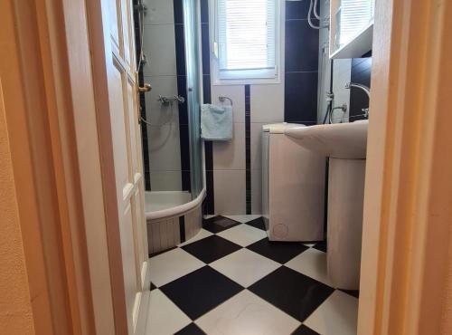 a bathroom with a black and white checkered floor at Villa Tena Rovinj Istria in Rovinj