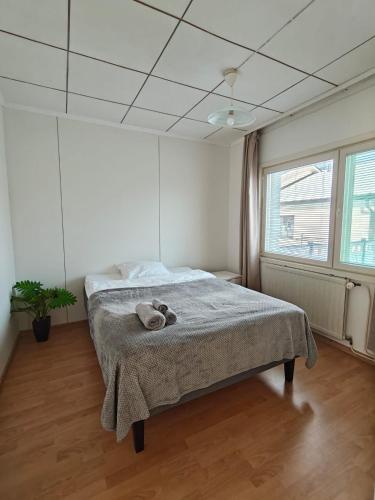a bedroom with a bed with a blanket on it at Simple Cozy House in Raahe