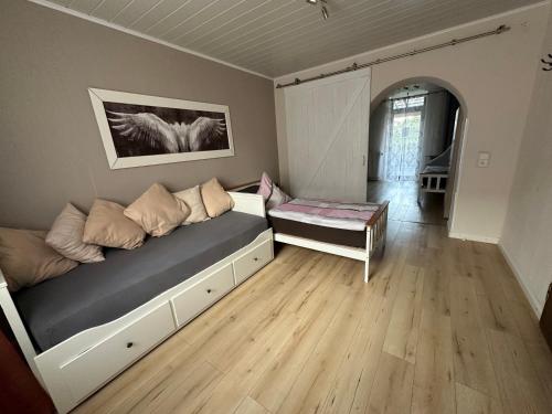 a room with a bed and a table in it at Palminas Monteur FeWo EG in Merzig