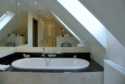 a bathroom with a sink and a mirror at Villa Orlik in Barlinek