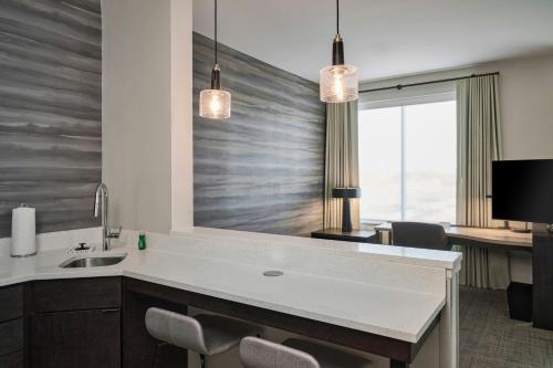 a kitchen with a sink and a large mirror at Residence Inn by Marriott Madison in Madison