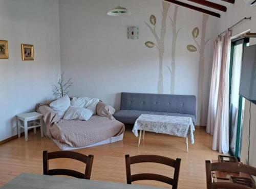 a living room with a couch and a table at Stomorska Seaside Apartments in Stomorska