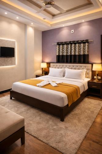a bedroom with a large bed in a room at New Mewar Darshan in Udaipur