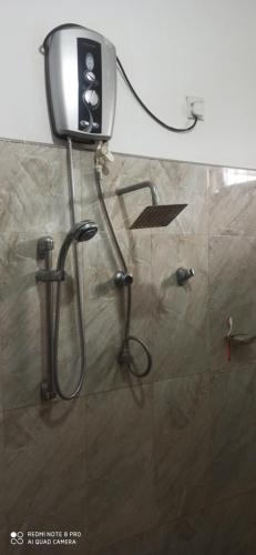 a shower in a bathroom with a shower head at Summerfield in Kandy