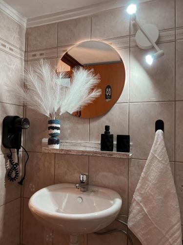 a bathroom with a sink and a mirror at Aurora Luxury Apartment in Keramoti