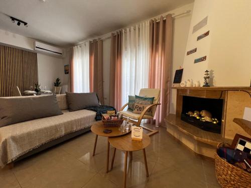 a living room with a couch and a fireplace at Aurora Luxury Apartment in Keramoti