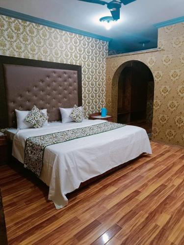 a bedroom with a large bed and a fireplace at New shalimar dal view in Srinagar