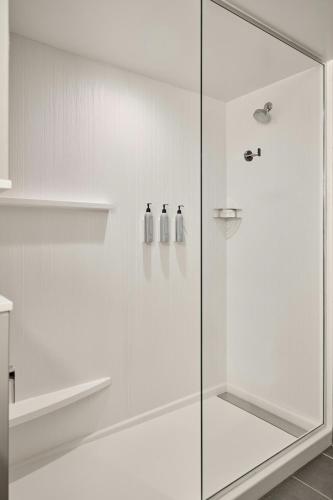 a shower with two bottles on a glass door at Courtyard by Marriott Madison in Madison