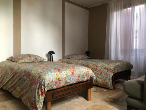 Llit o llits en una habitació de Le Marronnier