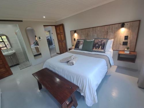 a large bedroom with two beds and a wooden headboard at White Sparrow Villa in Marloth Park