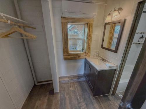 a bathroom with a sink and a mirror and a window at Salish Queen Mokee Shared Kitchen Pets OK! #1 in Bluff