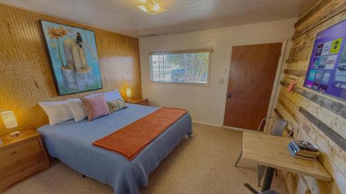 a bedroom with a bed and a wooden wall at Birds - King Suite Pets ok, Shared Kitchen #3 in Bluff
