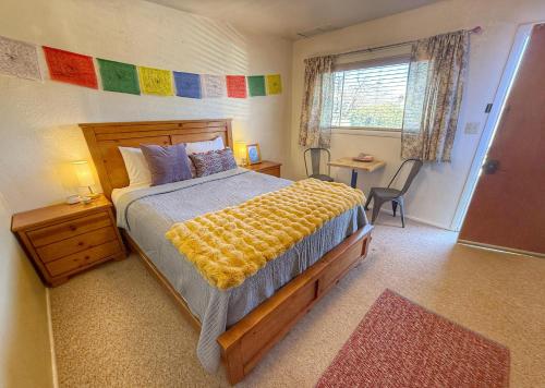 a bedroom with a bed with a yellow blanket on it at King Five Mokee Motel Pets OK Shared Kitchen in Bluff