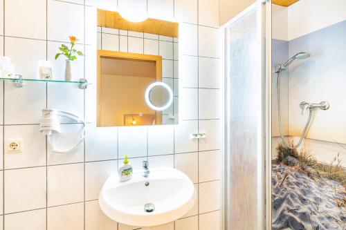 a bathroom with a sink and a shower at Pension Buchfink in Ueckeritz