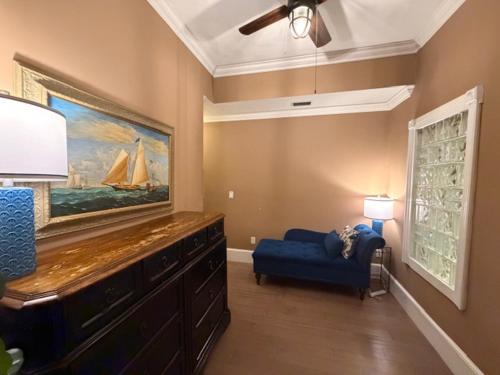 a living room with a blue couch and a painting at Casablanca Inn on the Bay in St. Augustine