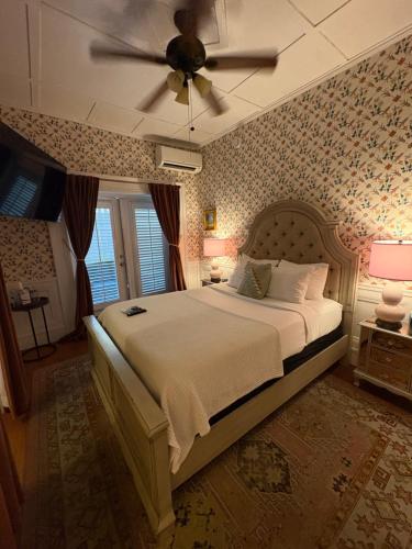 a bedroom with a bed with a ceiling fan at Casablanca Inn on the Bay in St. Augustine