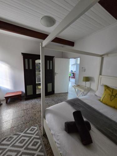 a bedroom with a large bed with a black object on it at Ocean Rush in Zinkwazi Beach