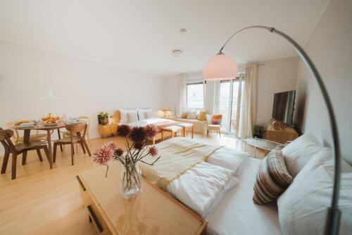 a living room with a couch and a table at Studio5 am Ringpark in Würzburg