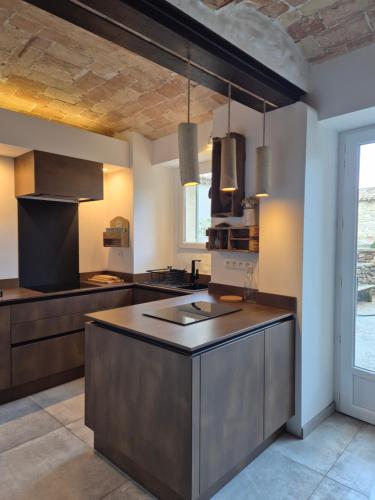 a kitchen with a large island in the middle at Mas des Aïeux in Laudun