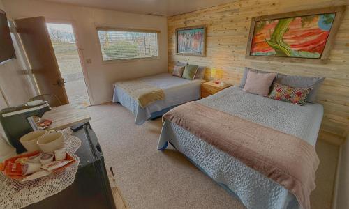 a small bedroom with two beds and a window at Pinion 6 Mokee in Bluff Kitchen, Sleeps 4 in Bluff