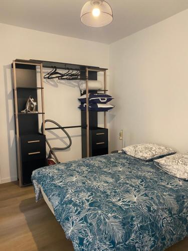 a bedroom with a bed and a book shelf at Gîte le Taurion in Saint-Priest-Taurion
