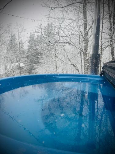 a view of a blue tub in the snow at M Cabin A Frame Predeal 2 Ciubar in Predeal