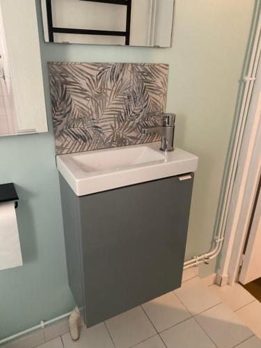 a sink in a bathroom with a wall at Gîte le Taurion in Saint-Priest-Taurion