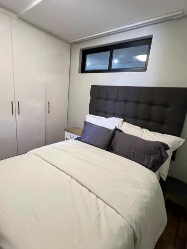 a bedroom with a large bed and a window at Finagaello 3 bedrooms-Self catering at 77 on Independence in Windhoek