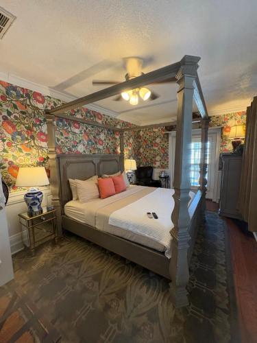 a bedroom with a bed with a ceiling fan at Casablanca Inn on the Bay in St. Augustine