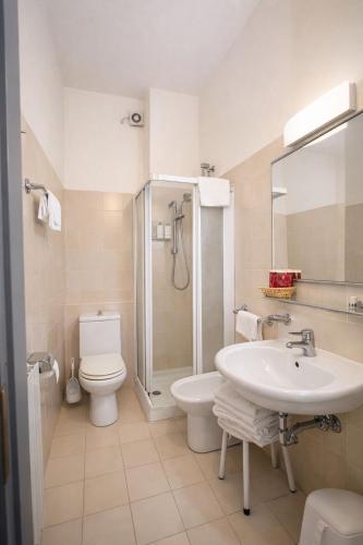 a bathroom with a sink and a toilet and a shower at Hotel Granducato in Montepulciano