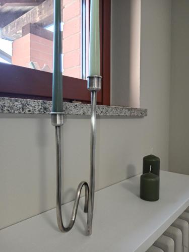 a candle sitting on a counter in a bathroom at ATHENA Home Asti in Asti