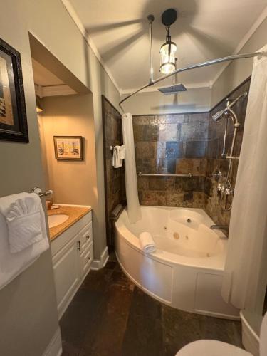 a bathroom with a large tub and a sink at Casablanca Inn on the Bay in St. Augustine