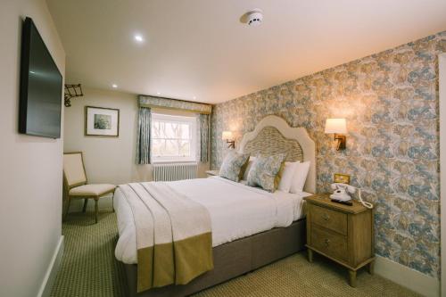 a bedroom with a large bed in a room at Mulberry House in Ongar