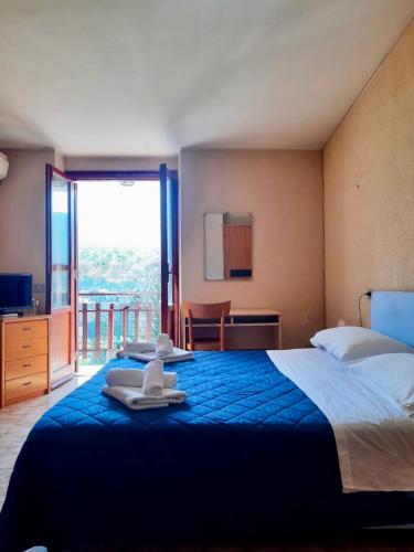 a bedroom with a large bed with towels on it at Hotel Monte Viglio in Filettino