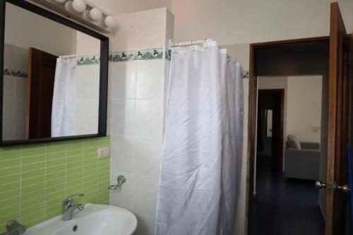 a bathroom with a sink and a mirror at Venus Bayahibe by Mireya in Bayahibe