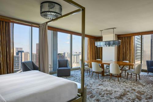 a bedroom with a bed and a table and chairs at Marriott Marquis Houston in Houston
