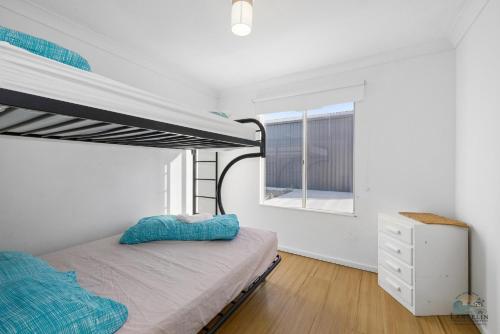 a bedroom with a bunk bed and a window at Sea Gem in Lancelin