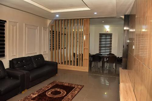 a living room with a couch and a dining room at 21 Suites & Apartments in Mama