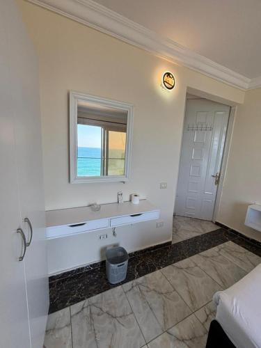 a white room with a sink and a window at Hayah Suites & Rooms in Alexandria