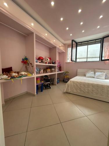 a bedroom with a large bed and a window at Martone house in Castellammare di Stabia