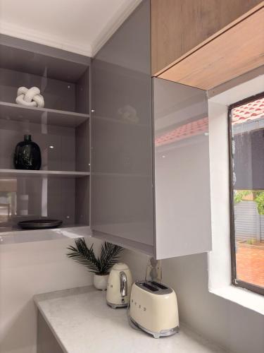 a kitchen with a counter with a toaster and a appliance at 101 Marais Villa in Hartbeespoort